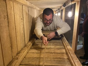Matthew Davidson, the grandson of Second World Great Escape figure Barry Davidson, tries out a re-creation of the POWs' escape tunnel at The Military Museums