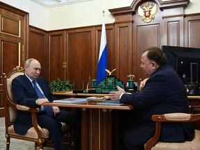 Russia's President Vladimir Putin (L) attends a meeting with Inigushetia's regional head Makhmud-Ali Kalimatov in Moscow's Kremlin, on Aug. 15, 2023.