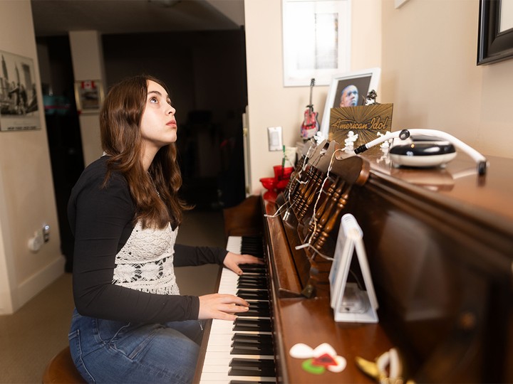  Teen musician Kaiya Gamble practices at the family piano in her home northwest of Calgary on Wednesday, March 27, 2024.