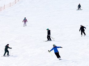 Skiers at WinSport in late March
