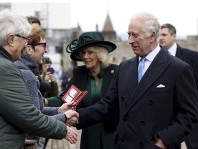 Britain's King Charles III and Queen Camilla greet people after attending the Easter Matins Service at St. George's Chapel, Windsor Castle, England, Sunday, March 31, 2024.