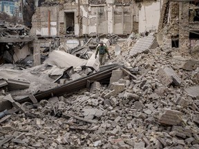 A Ukrainian serviceman inspects the damage to a building at the Pecherskyi district, after a Russian air attack in Kyiv, Ukraine, Monday March 25.