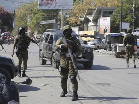 Members of the General Security Unit of the National Palace, USGPN, set up a security perimeter after armed gang members tried to seize the National Palace the day before, in Port-au-Prince.