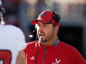 Eastern Washington head coach Beau Baldwin speaks with his team during a timeout during the first half of an NCAA college football game against the Washington State in Pullman, Wash., Saturday,