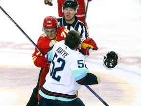 Calgary Flames Martin Pospisil battles Seattle Kraken Tye Kartye in second period NHL action at the Scotiabank Saddledome in Calgary