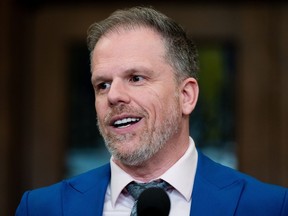 Health Minister Mark Holland speaks to reporters in the Foyer of the House of Commons on Parliament Hill in Ottawa, on Wednesday, March 20, 2024.