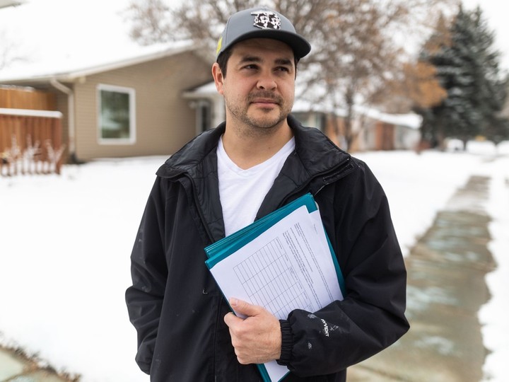  Calgarian Landon Johnston, pictured with a stack of petition sheets, on Tuesday, February 6, 2024,., part of his efforts to recall Mayor Jyoti Gondek.