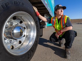 Rachel Benson, a Women Building Futures alumnus who drives for Rosenau Transport, with a semi-truck and trailer on March 18, 2024, in Edmonton.