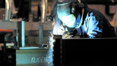 A welder is seen working in a factory in Quebec City in this photo from Feb. 28, 2012.
