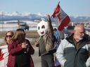 Demonstrators gather on the side of the Trans-Canada Highway west of Calgary to protest the federal carbon tax on Monday, April 1, 2024. The gathering reduced Highway 1 to a single westbound lane just west of the Highway 22 junction. 