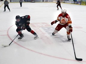 Whitecourt Wolverines player Spencer Rheaume tried to keep the puck away from the Calgary Canucks' Ethan