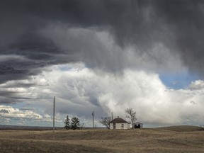 Storm clouds roll in over an old farmstead east of Elnora, Ab., on Tuesday, April 9, 2024.