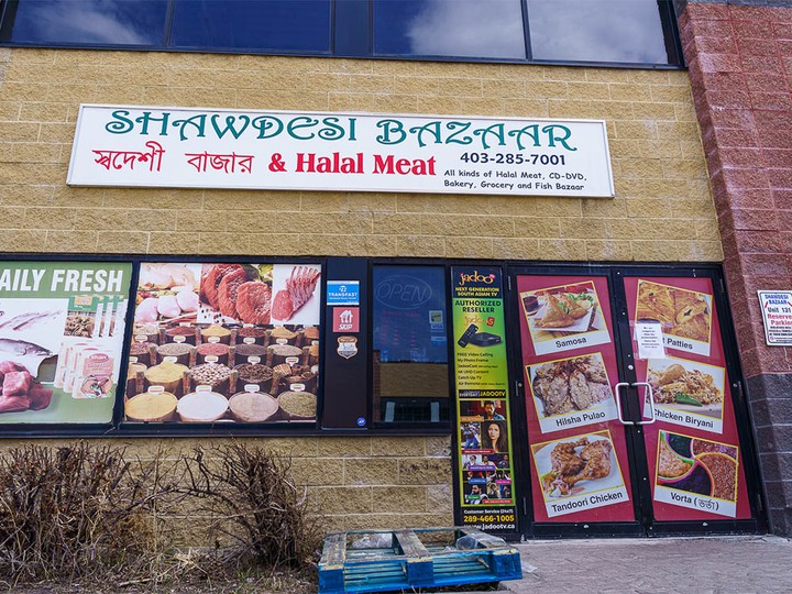  Closure signage pictured at Shawdesi Bazaar in northeast Calgary on Monday, April 22, 2024. AHS issued closure orders for several grocery stores accused of buying and selling uninspected meat.