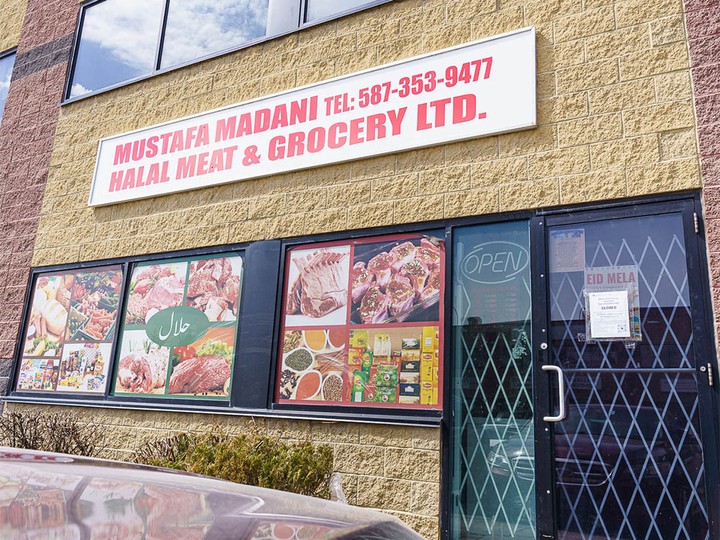  Closure signage pictured at Mustafa Madani Halal Meat and Groceries in northeast Calgary on Monday, April 22, 2024. AHS issued closure orders for several grocery stores accused of buying and selling uninspected meat.