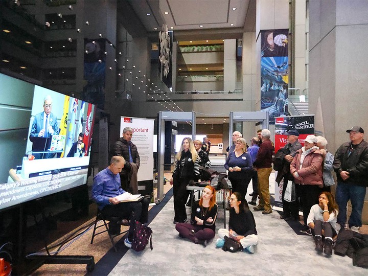  Observers gather in the overflow area in the atrium at City Hall in Calgary on Monday, April 22, 2024. Council began hearing public speakers and submissions associated with the proposed rezoning bylaw.
