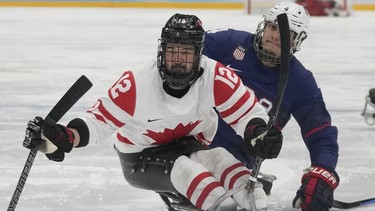 The Canadian team attempting to reclaim a world para hockey championship on home ice was announced Thursday by Hockey Canada. Greg Westlake, left, of Canada and Brody Roybal of the United States battle for the puck during their para ice hockey finals match at the 2022 Winter Paralympics in Beijing, Sunday, March 13, 2022.