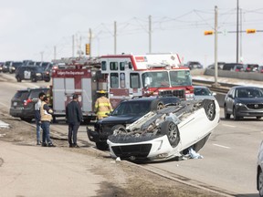 Emergency crews work at the scene of a multi-vehicle collision with a rollover on southbound 36 Street NE near 12 Avenue in Calgary on Saturday, April 6, 2024. Police at the scene confirmed there were no serious injuries, however firefighters had to extricate one entrapped occupant from the flipped vehicle. Brent Calver/Postmedia