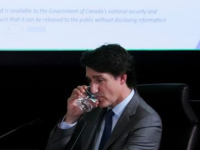 A document is displayed on a screen behind Prime Minister Justin Trudeau as he appears as a witness at the Public Inquiry Into Foreign Interference in Federal Electoral Processes and Democratic Institutions in Ottawa on Wednesday, April 10, 2024.