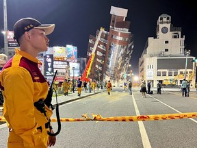 A rescue worker stands near the cordoned off site of a damaged building in the aftermath of an earthquake in Hualien, Taiwan, April 3, 2024.