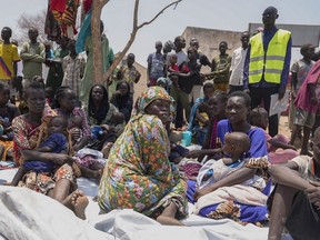 South Sudanese who fled from Sudan sit outside a nutrition clinic at a transit center in Renk, South Sudan, on May 16, 2023.