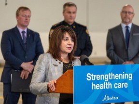 Health Minister Adriana LaGrange announces funding to reduce emergency response times and support EMS workers on Thursday, April 11, 2024, in Edmonton. Behind her are Martin Long, parliamentary secretary for rural health, Marty Scott, executive director, EMS provincial programs and Tim Ford, registrar, Alberta College of Paramedics.