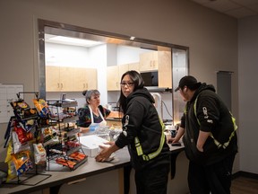 Workers stop for lunch at the arena, one of many infrastructure and service projects the community of 700 has been able to fund through its relationship with the industry, in Fort McKay, Alta., Thursday, April 25, 2024. Chief Raymond Powder says while indigenous communities had no say in the development of the tar sands in the first place;  Now that they are here, he is doing everything he can to take advantage of opportunities for his community.
