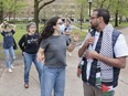 Pro Israel protesters (left) are separated from pro Palestine supporters at an encampment on the campus of the University of Michigan in Ann Arbor, Michigan on April 28, 2024.