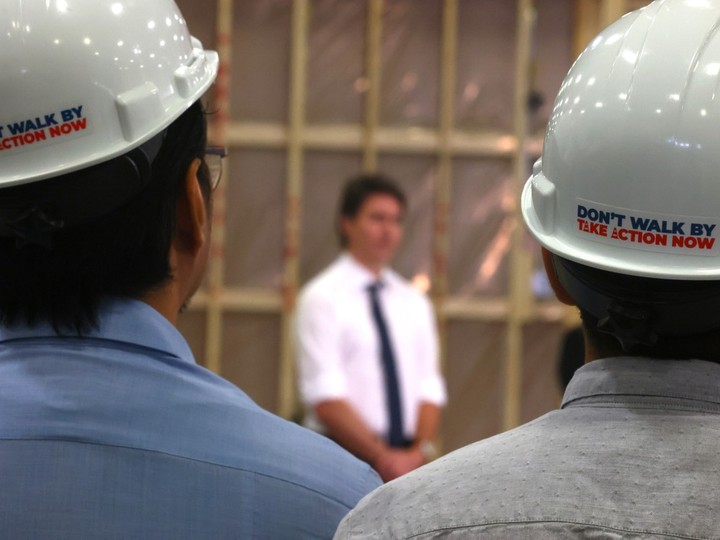  Workers listen as Prime Minister Justin Trudeau made a housing announcement at NRB Modular Solutions in Calgary on Friday, April 5, 2024.