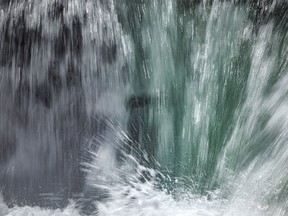 Ice behind the crashing water shows up green in Sheep River Falls in Sheep River in Sheep River Provincial Park west of Diamond Valley, Ab., on Tuesday, May 28, 2024.