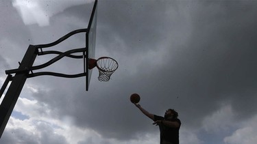Basketball in Bridgeland under stormy skies