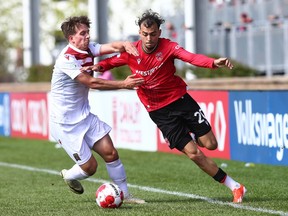 Valour FC defender Noah Verhoeven (L) marks Cavalry FC Lucas Dias during CPL soccer action on ATCO Field at Spruce Meadows in Calgary