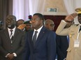 FILE - Togo's President, Faure Gnassingbé, centre, looks on, prior to the start of the ECOWAS meeting, in Abuja, Nigeria, Saturday, Feb. 24, 2024. Togolese voters headed to the polls on Monday, April 29, 2024, to vote in the country's parliamentary elections that will test support for a proposed new constitution that would scrap future presidential elections and give lawmakers the power to choose the president instead.