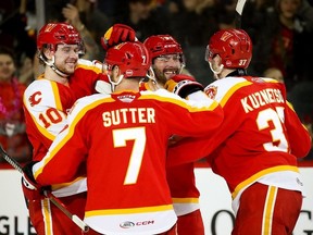 The Calgary Wranglers celebrate during their Game 1 win over the Coachella Valley Firebirds in their Pacific Division semifinal at Scotiabank Saddledome in Calgary