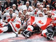 Team Canada celebrate defeating Team USA to win the World Para Ice Hockey Championship final in Calgary