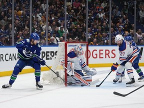 Edmonton Oilers goalie Calvin Pickard stops Vancouver Canucks' Elias Pettersson as Oilers' Brett Kulak defends during the first period in Game 5 of an NHL hockey Stanley Cup second-round playoff series, in Vancouver, on Thursday, May 16, 2024.