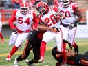 Calgary Stampeders running back Peyton Logan battles the B.C. Lions in pre-season action at McMahon Stadium in Calgary on Saturday, May 25, 2024.