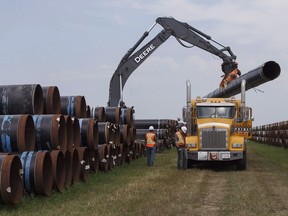 Pipe is unloaded at a project in Hardisty, Alta., on Thursday, Aug.10, 2017.