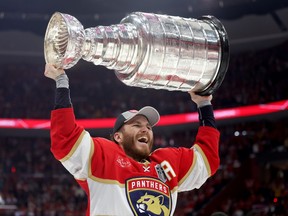 Matthew Tkachuk #19 of the Florida Panthers lifts the Stanley Cup after Florida's 2-1 victory against the Edmonton Oilers in Game Seven of the 2024 Stanley Cup Final at Amerant Bank Arena on June 24, 2024 i