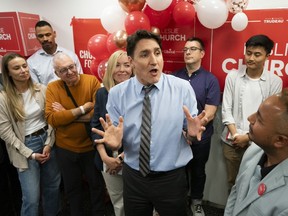Liberal candidate for Toronto-St. Paul’s, Leslie Church, left, watches as Liberal Leader Justin Trudeau, centre, speaks to supporters at a campaign volunteer event, in Toronto on Thursday, May 30, 2024. THE CANADIAN PRESS/Arlyn McAdorey