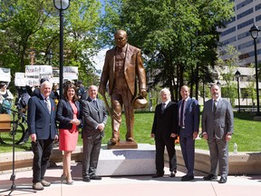 Bill Bewick, Premier Danielle Smith, Randolph Churchill, Danek Mozdzenski, Mark Milke, and Jason Kenney pose next to the statue of Sir Winston Churchill after its unveiling at the McDougall Centre in Calgary on Thursday, June 6, 2024.