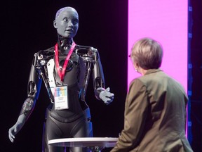 Ameca, a humanoid robot created by Engineered Arts, takes part in an AI interview with Alberta Innovates CEO Laura Kilcrease during Inventures at the Telus Convention Centre in Calgary on Wednesday, May 29, 2024.