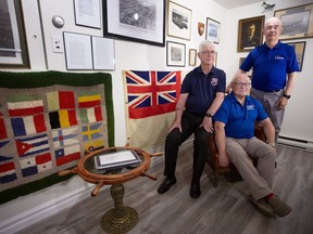 Berkley Lawrence (centre), along with Frank Sullivan (left) and Gary Browne, legion members who helped bring the remains of an unknown Newfoundland soldier home, pose for a picture at the Legion Branch 56 in St. John's on Tuesday, June 25, 2024.