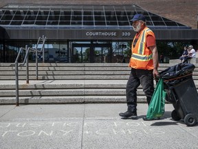 A jury is set to return today to hear evidence in the trial of two men charged with conspiracy to commit murder at the 2022 border blockade at Coutts, Alta. A city employees walks over words of support chalked on the sidewalk outside the courthouse as the trial for two men charged with conspiracy to commit murder during the border protest at Coutts, Alta., gets underway in Lethbridge, Alta., Thursday, June 6, 2024.