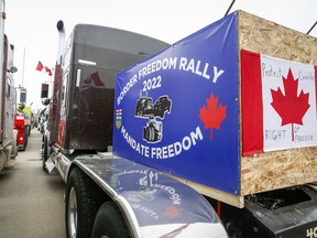 Anti-mandate demonstrators gather as a truck convoy blocks the highway at the busy U.S. border crossing in Coutts, Alta., Monday, Jan. 31, 2022. An undercover police officer is set to face more cross-examination today at the murder-conspiracy trial of two protesters at the border blockade at Coutts, Alta.