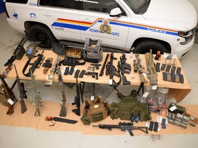 Weapons and ammunition seized by the RCMP are shown in this handout photo. An RCMP officer has told a murder-conspiracy trial that several weapons were discovered inside a travel trailer near the 2022 border blockade at Coutts, Alta.