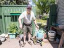 Allan Chanin, 98, uses a wagon to move his watering cans around the gardens of his Varsity home. Chanin, who draws water from rain barrels, has no trouble doing his part to conserve water.