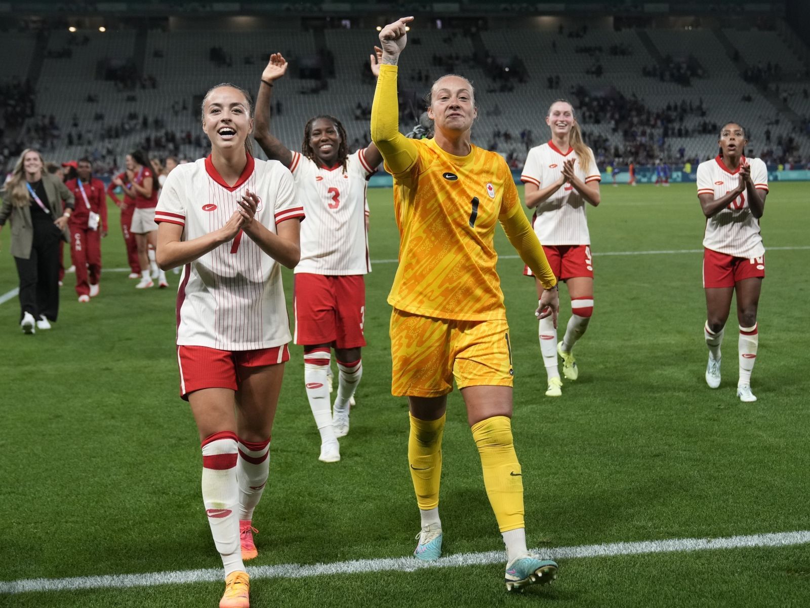 Canada celebrates their side's 2-1 win at the end of the women's Group A soccer match between Canada and France.