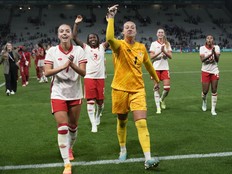 Canada celebrates their side's 2-1 win at the end of the women's Group A soccer match between Canada and France.