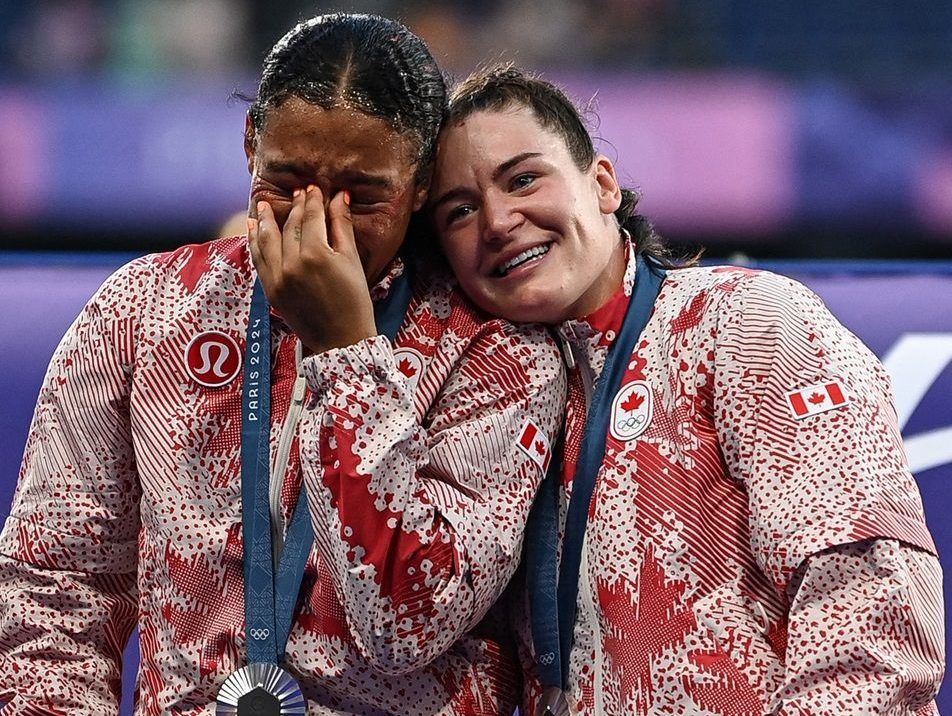 Canadian players celebrate with their silver medals on the podium during the victory ceremony following the women’s gold medal rugby sevens match between New Zealand and Canada in Saint-Denis on Tuesday.