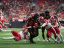 B.C. Lions' Terry Williams (87) is tackled by Calgary Stampeders' Adam Konar (38) during the second half of a CFL football game, in Vancouver, on Saturday, June 15, 2024.